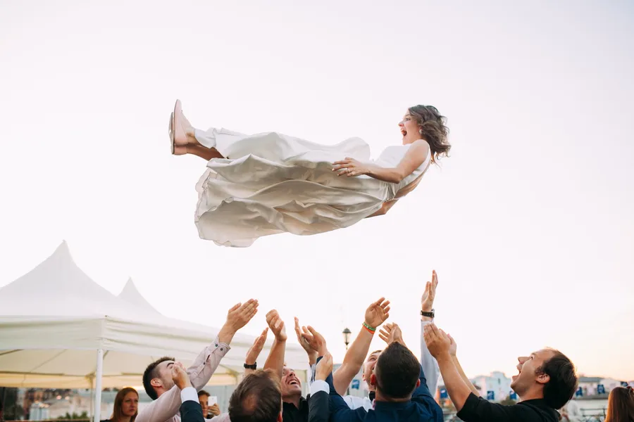 Wedding bride sent in the air by male friends